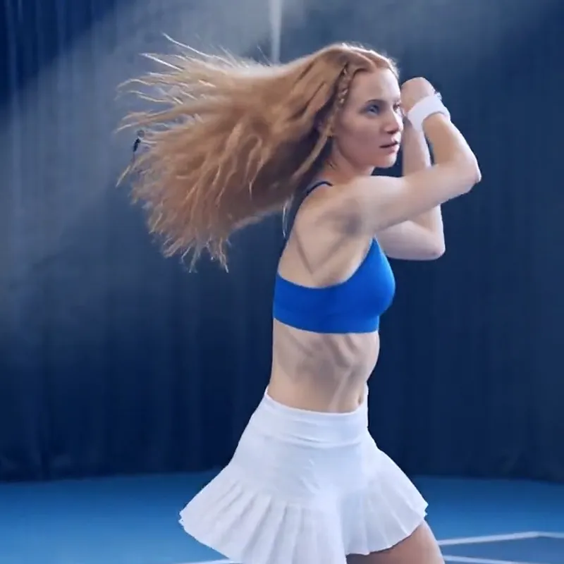A tennis player mid-swing, hair flying, from the TennisCut film Best of Us